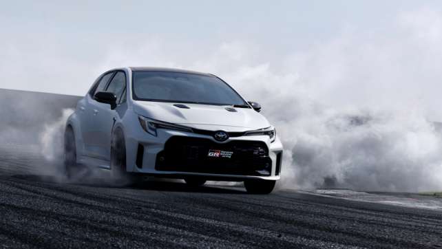 picture of GR Toyota Corolla going down a track with smoke behind it